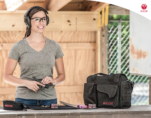 Woman smiling holding gun